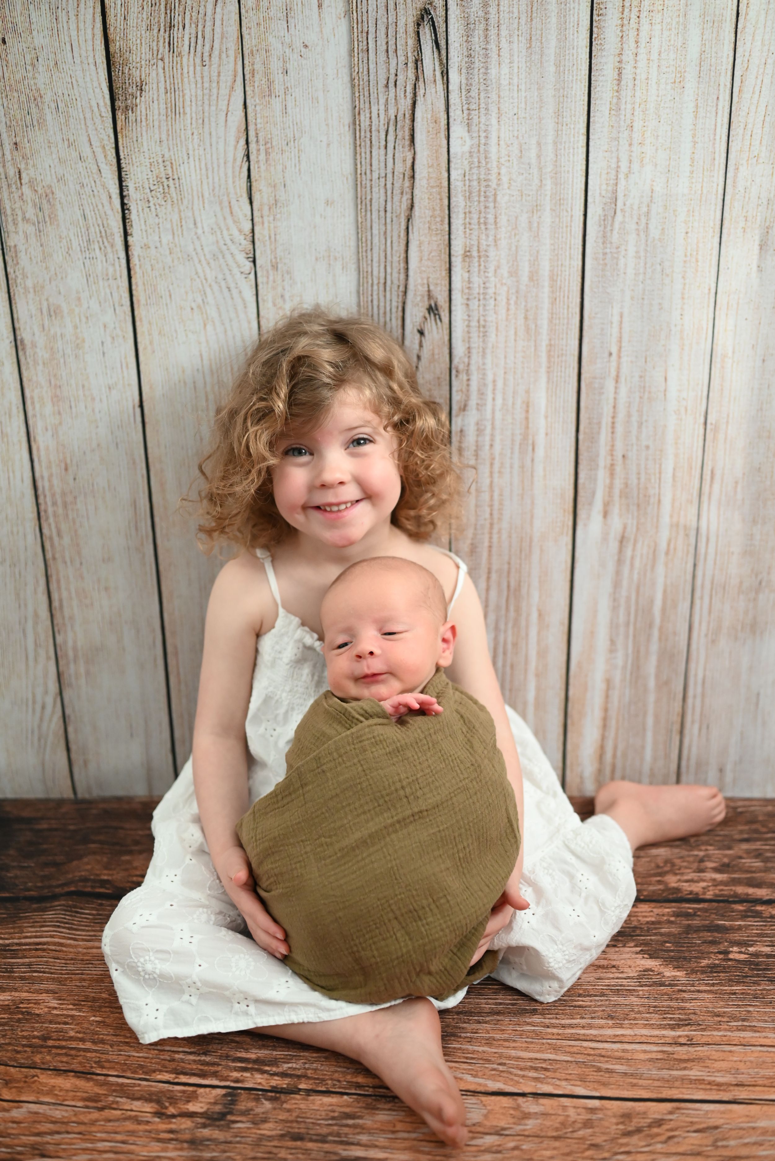 A series of sweet sibling portraits showing tender moments on a rustic wood backdrop.
