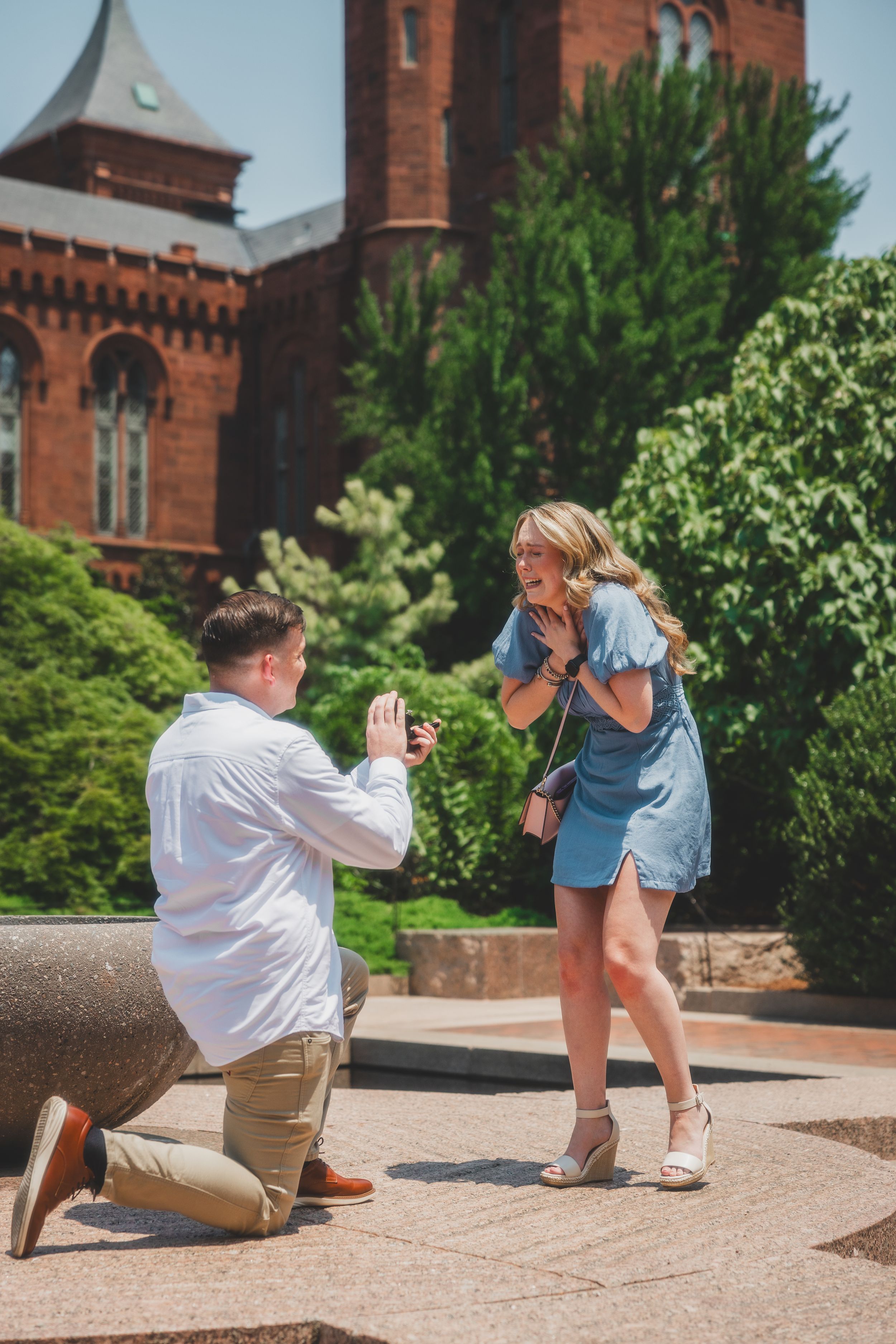 A proposal moment captured in sequence showing a couple on stone steps outside a historic brick building.