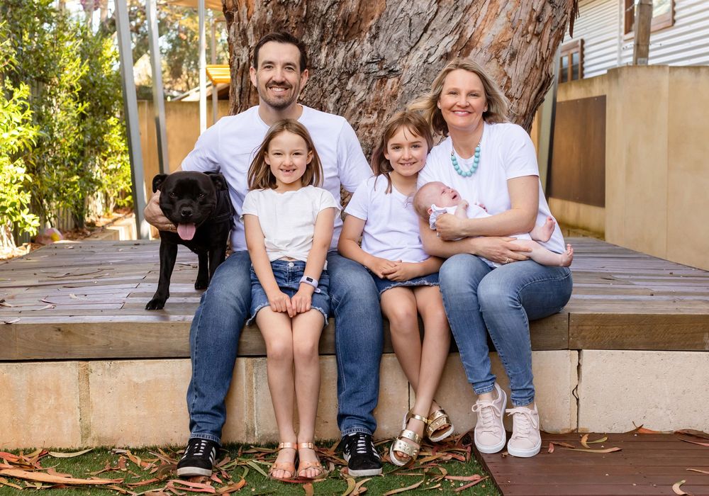 A series of casual outdoor family portraits showing people sitting together on wooden benches and steps in matching outfits.