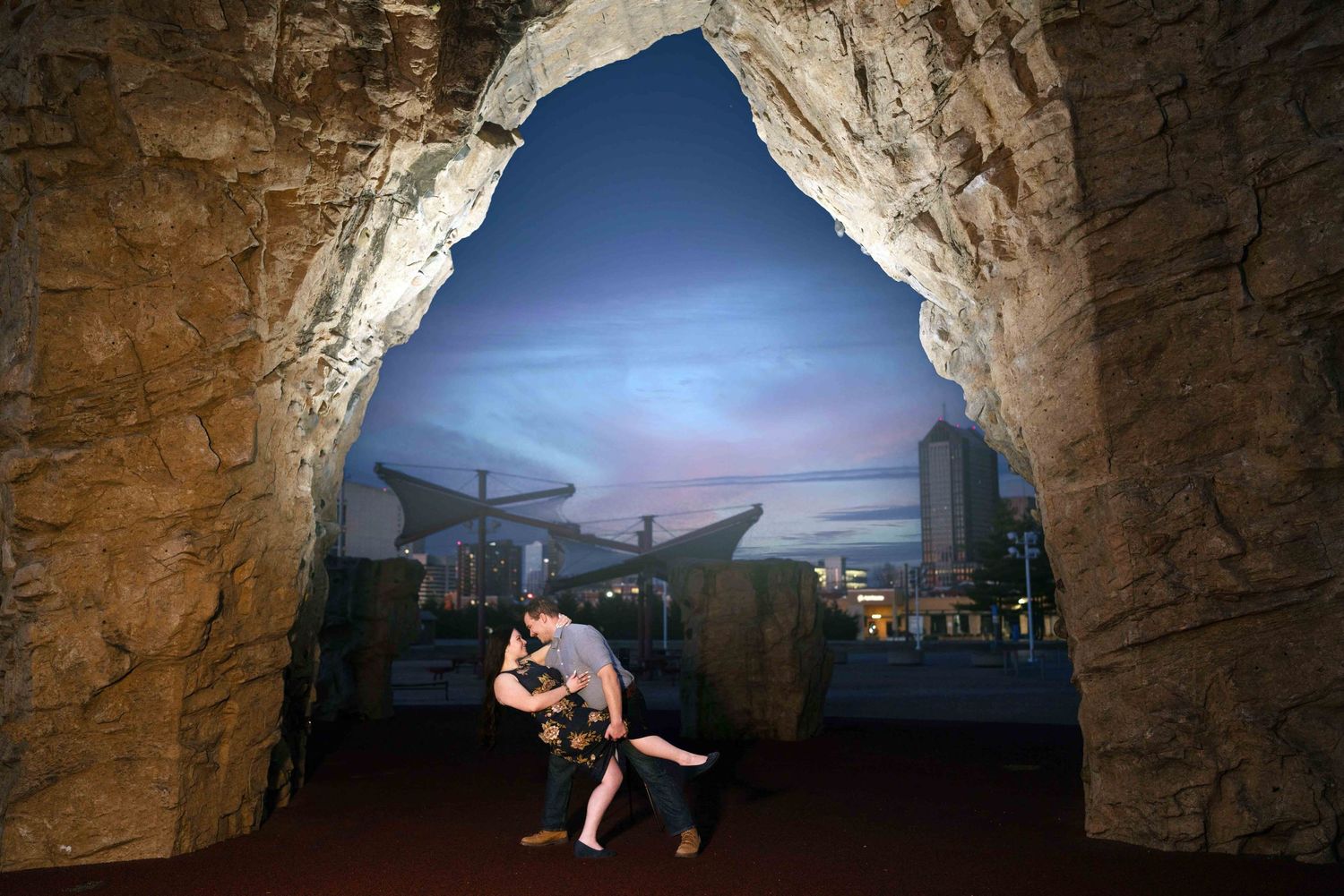 a couple dip and kiss during their engagement session
