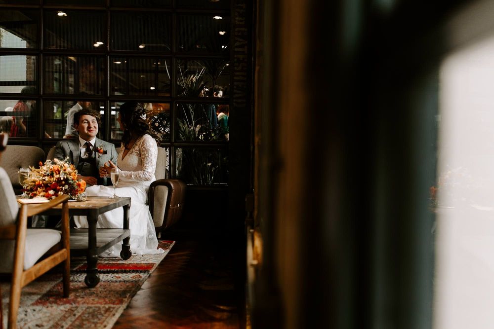 A romantic indoor dining scene with warm lighting and rustic decor at an intimate restaurant setting.