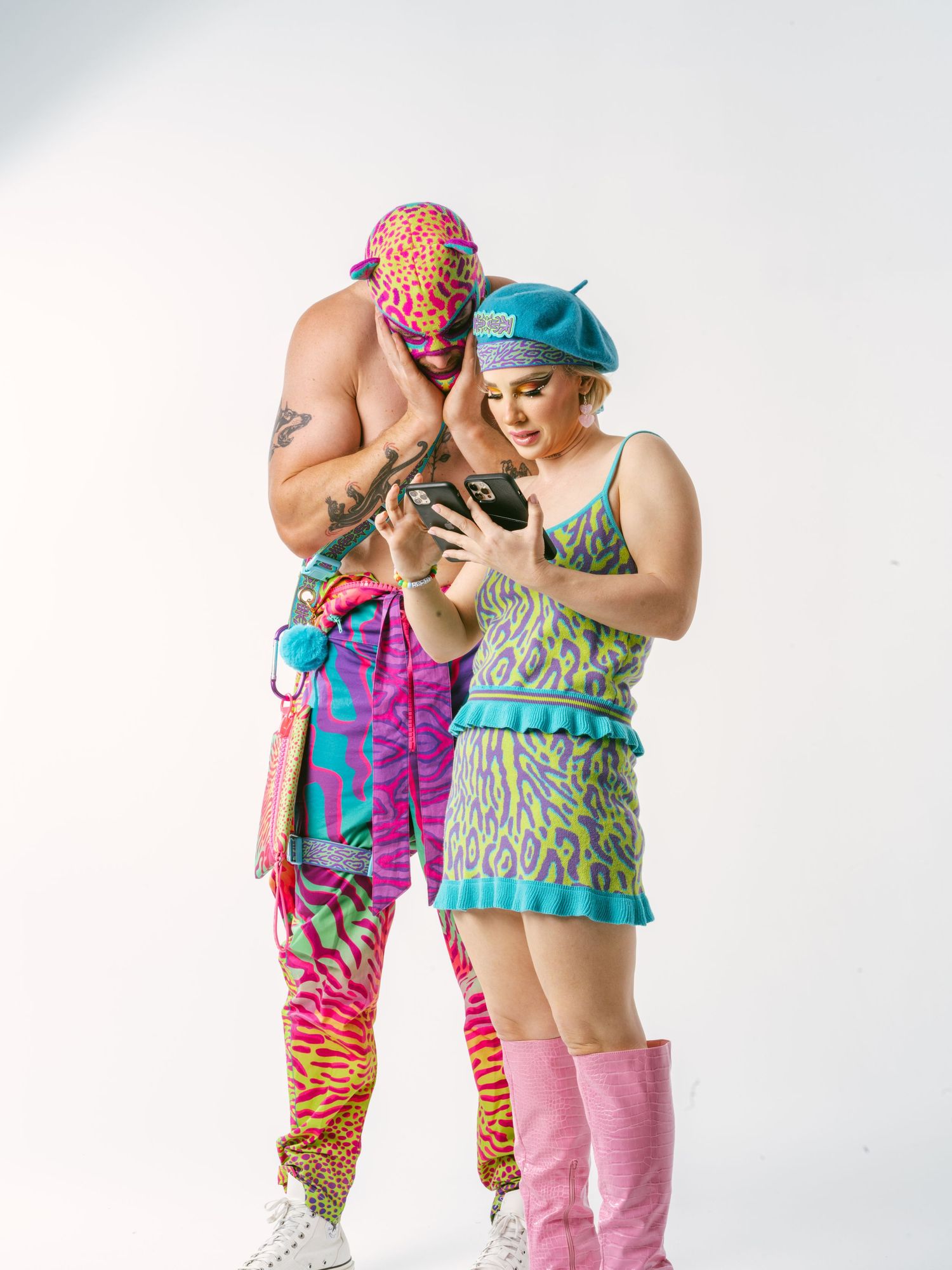 Two dancers in colorful athletic wear strike dynamic poses against a white background.