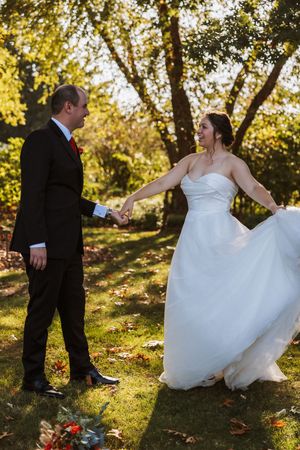 Couple dance in the golden hour light in Lansing during their wedding portraits by Rachel Martinez Photography. Michigan Wedding Photography