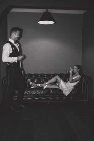 Vintage black and white photo series showing people working at a bar counter in dim lighting.