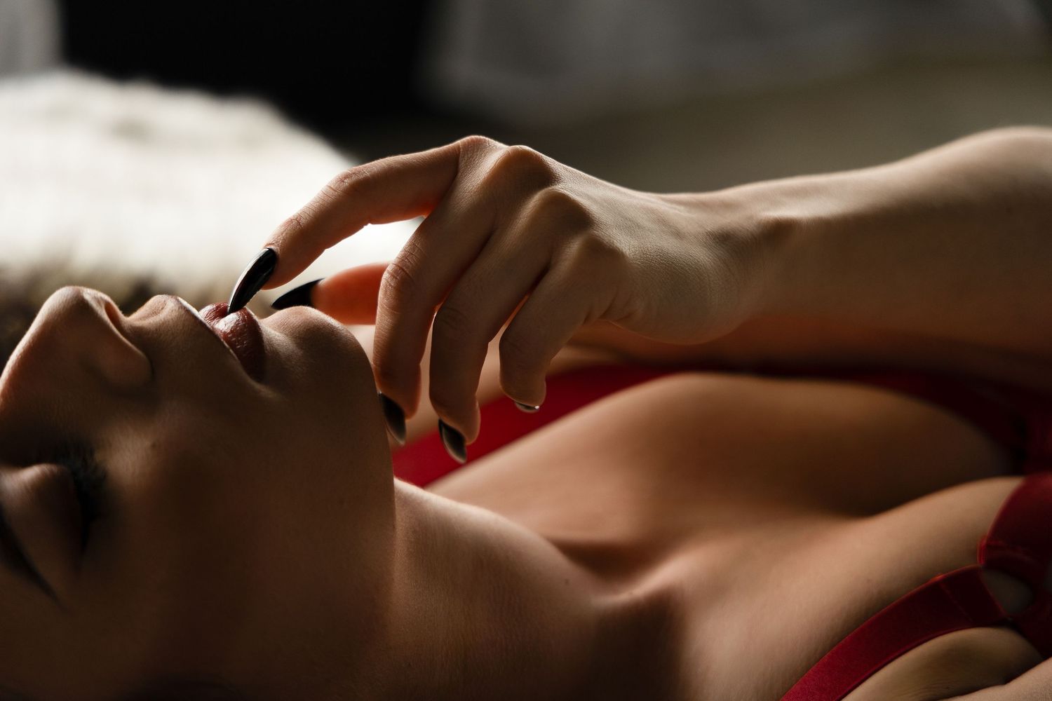 Close-up detail of manicured nails during a boudoir photography session