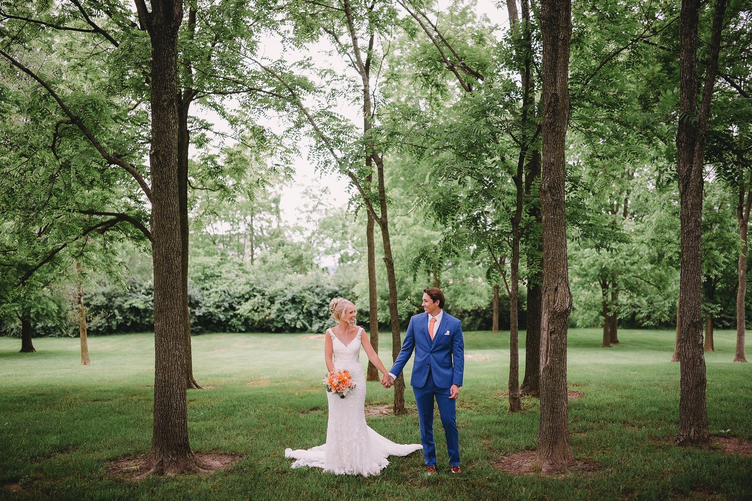 Bride and groom having their picture taken in a beautiful forest