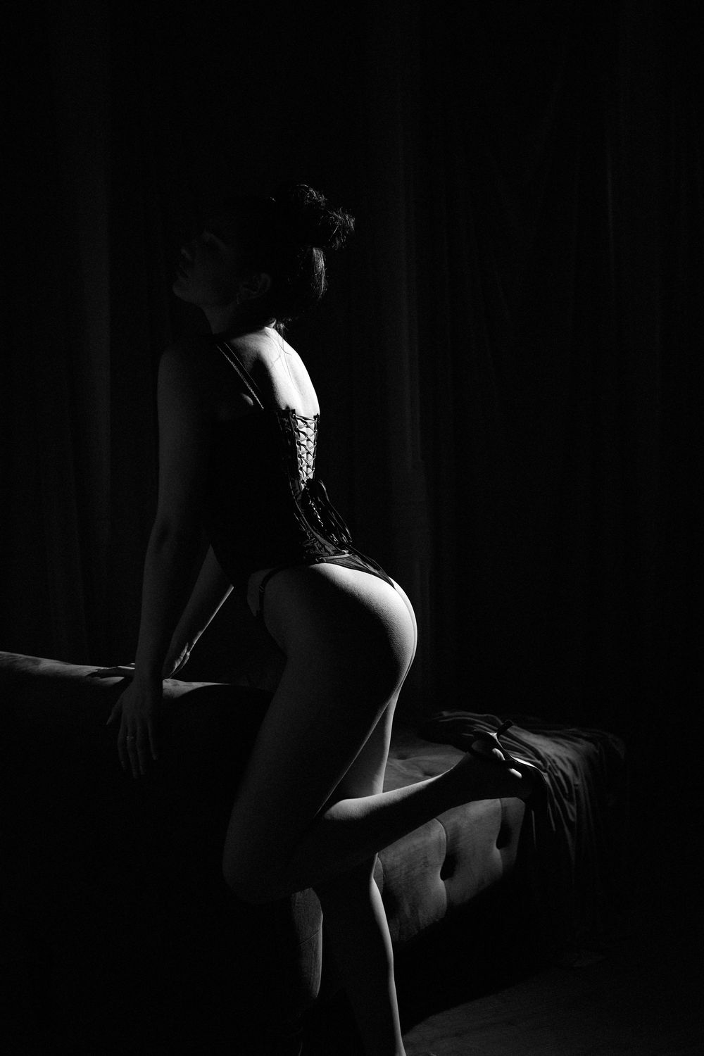 Artistic silhouettes in dark monochrome lighting creating mysterious shadows.