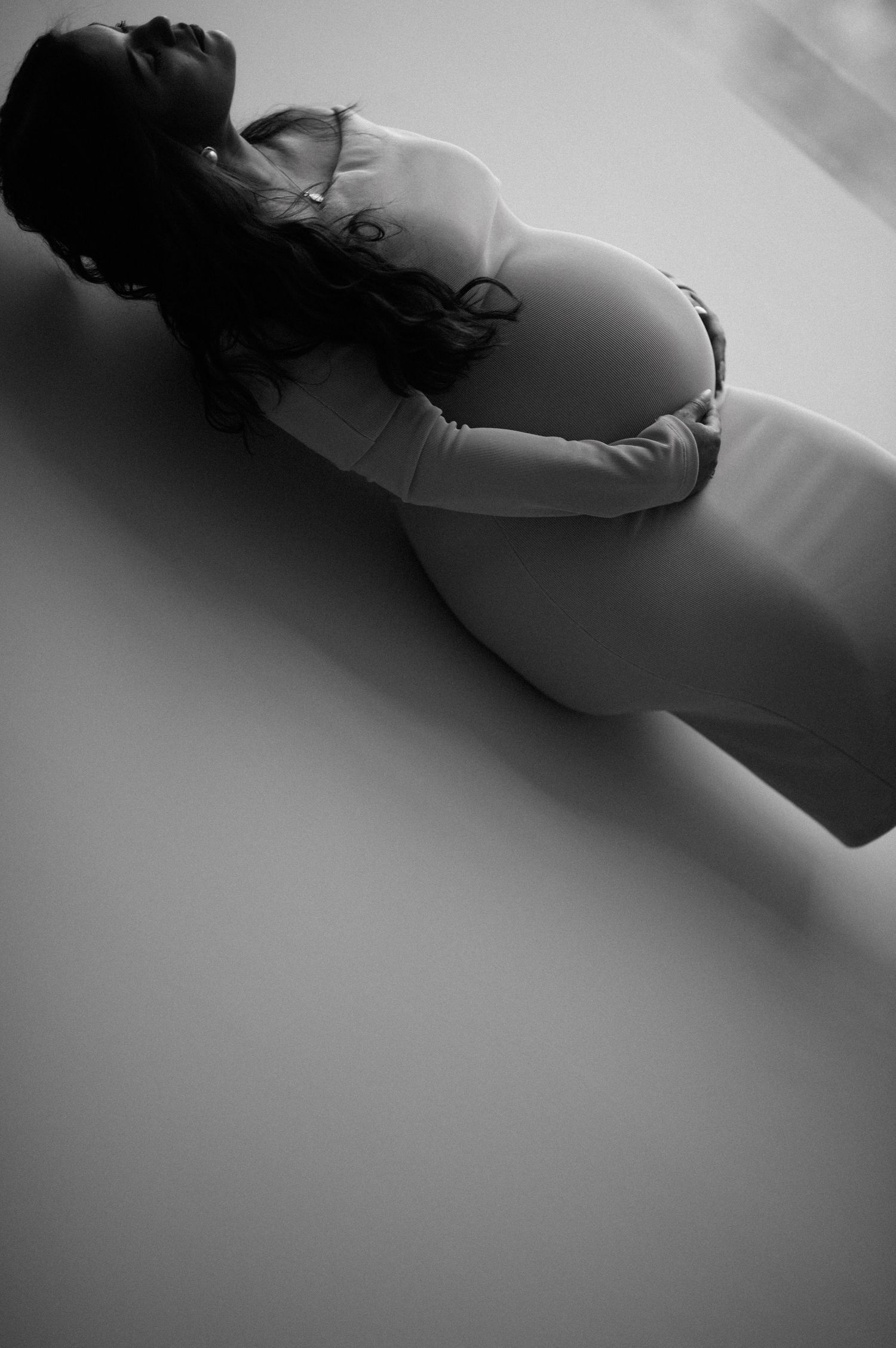 A black and white artistic photo sequence showing a reclining figure in soft focus with dramatic shadows and lighting.