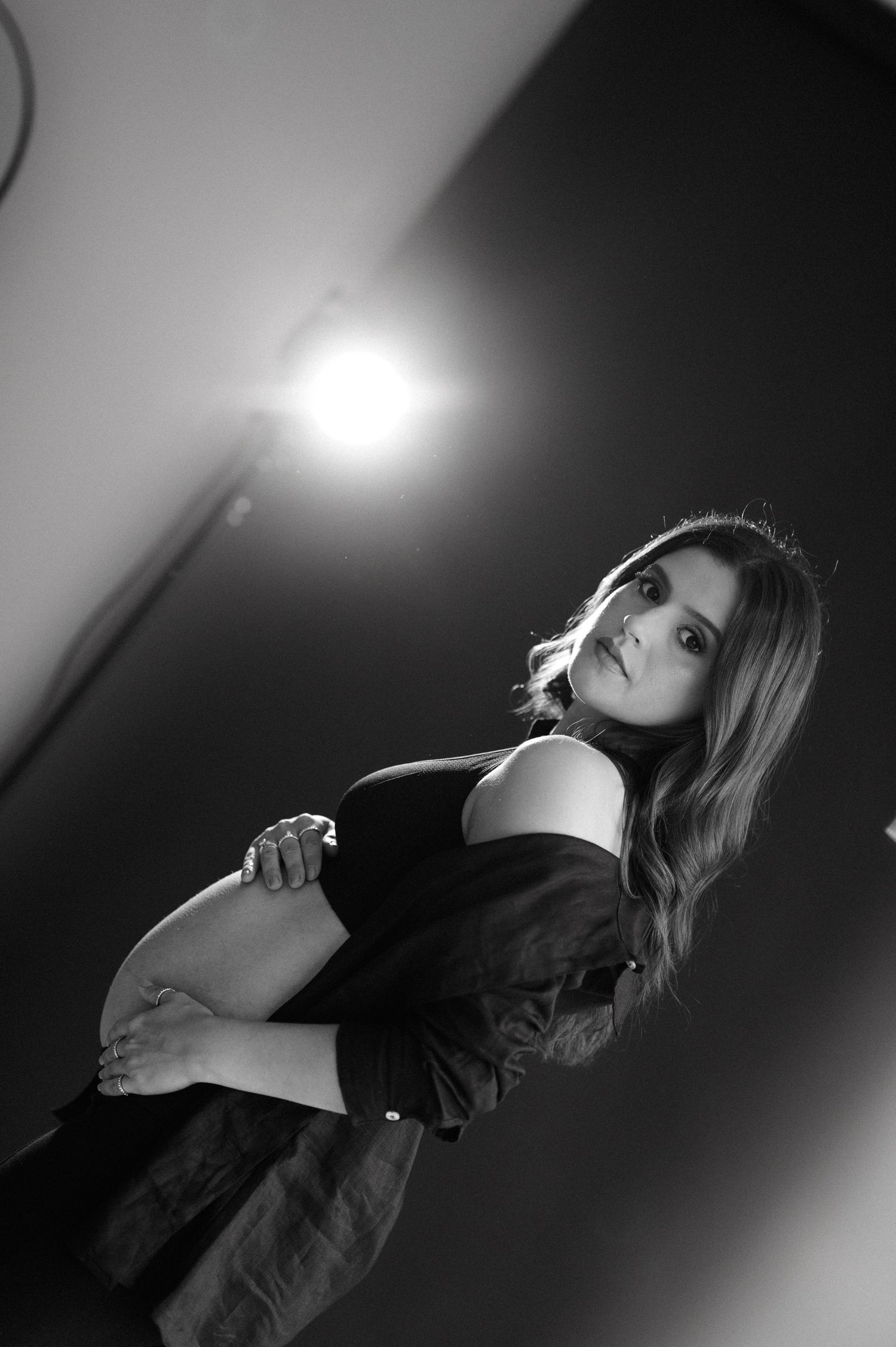 A dramatic black and white photo series shows a figure in silhouette against moody lighting creating an artistic composition.