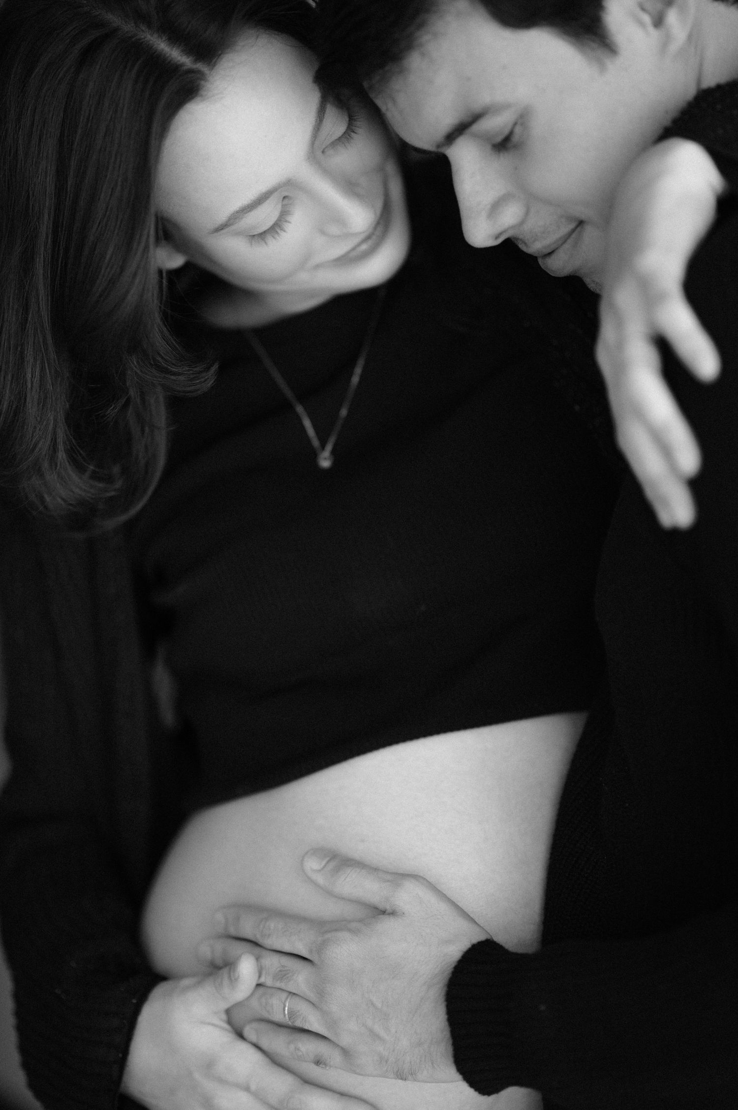 A romantic black and white photo series showing intimate moments between a couple in close embrace.