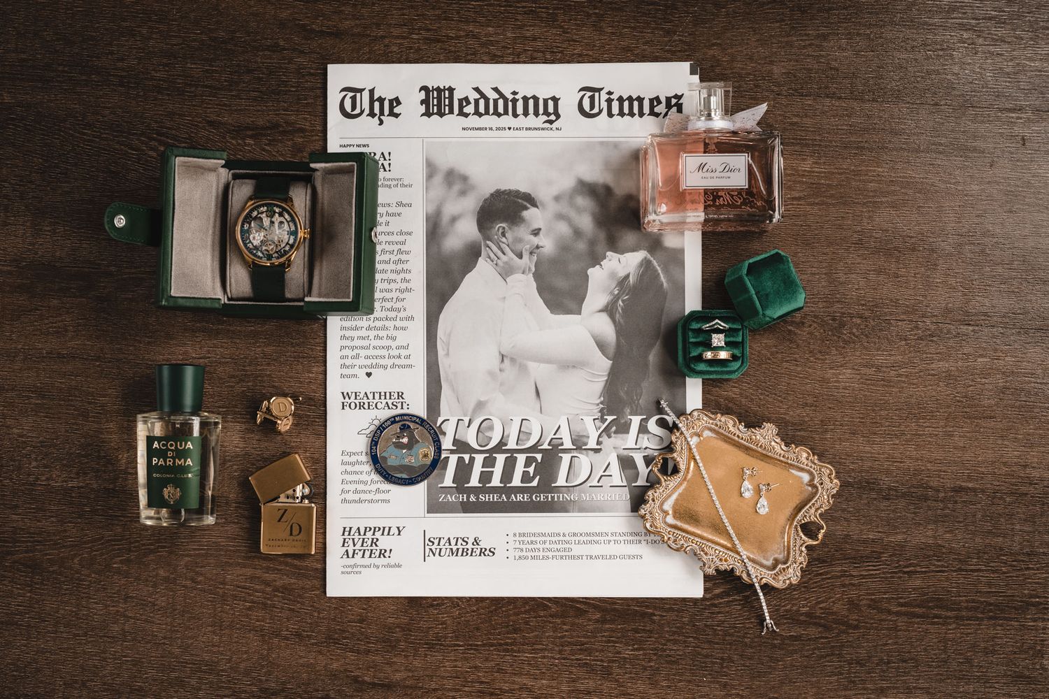 Wedding details flatlay with newspaper announcement, vintage camera and decorative elements.