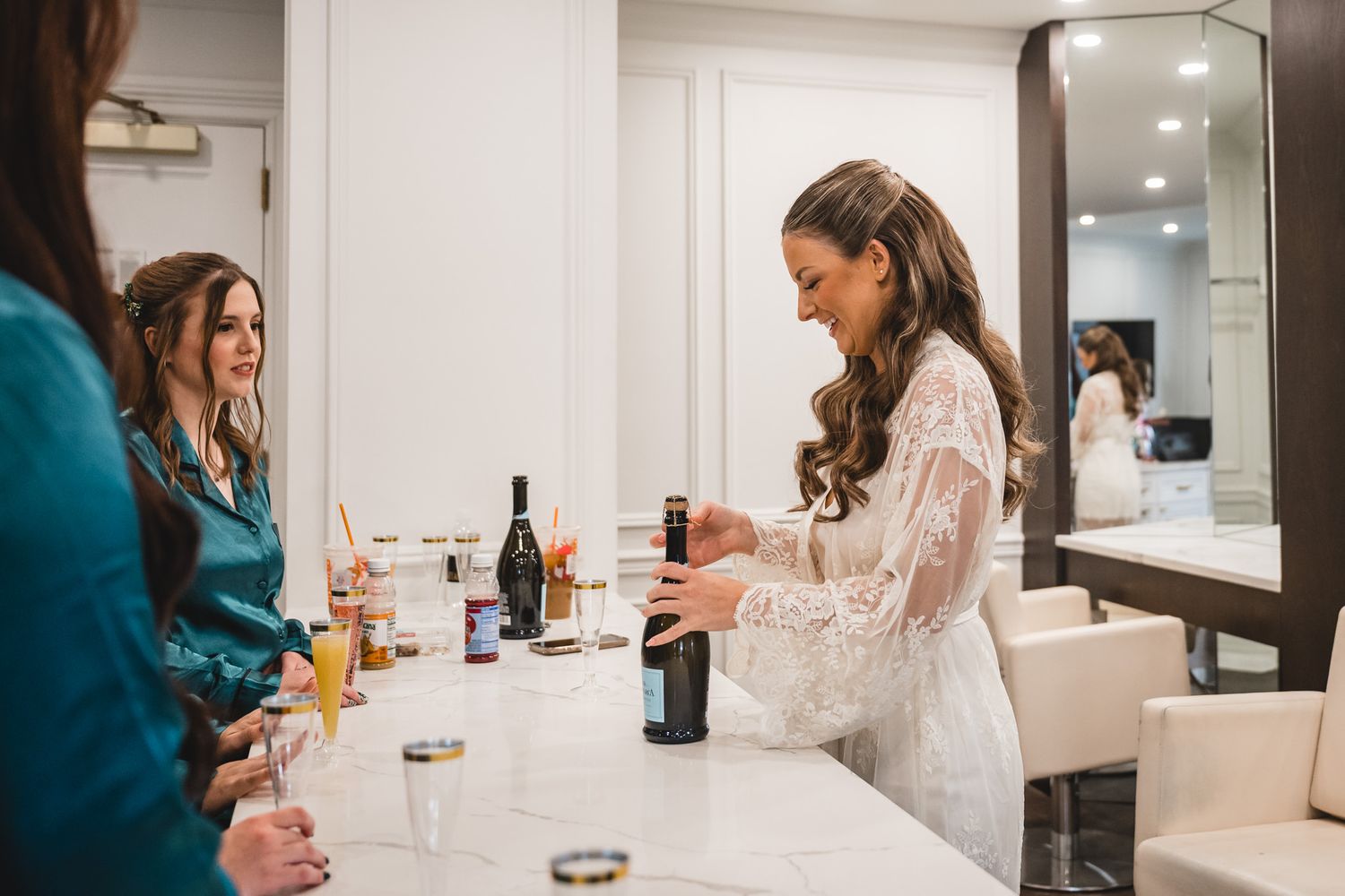 Wedding preparation scene with drinks and celebration in getting ready room.