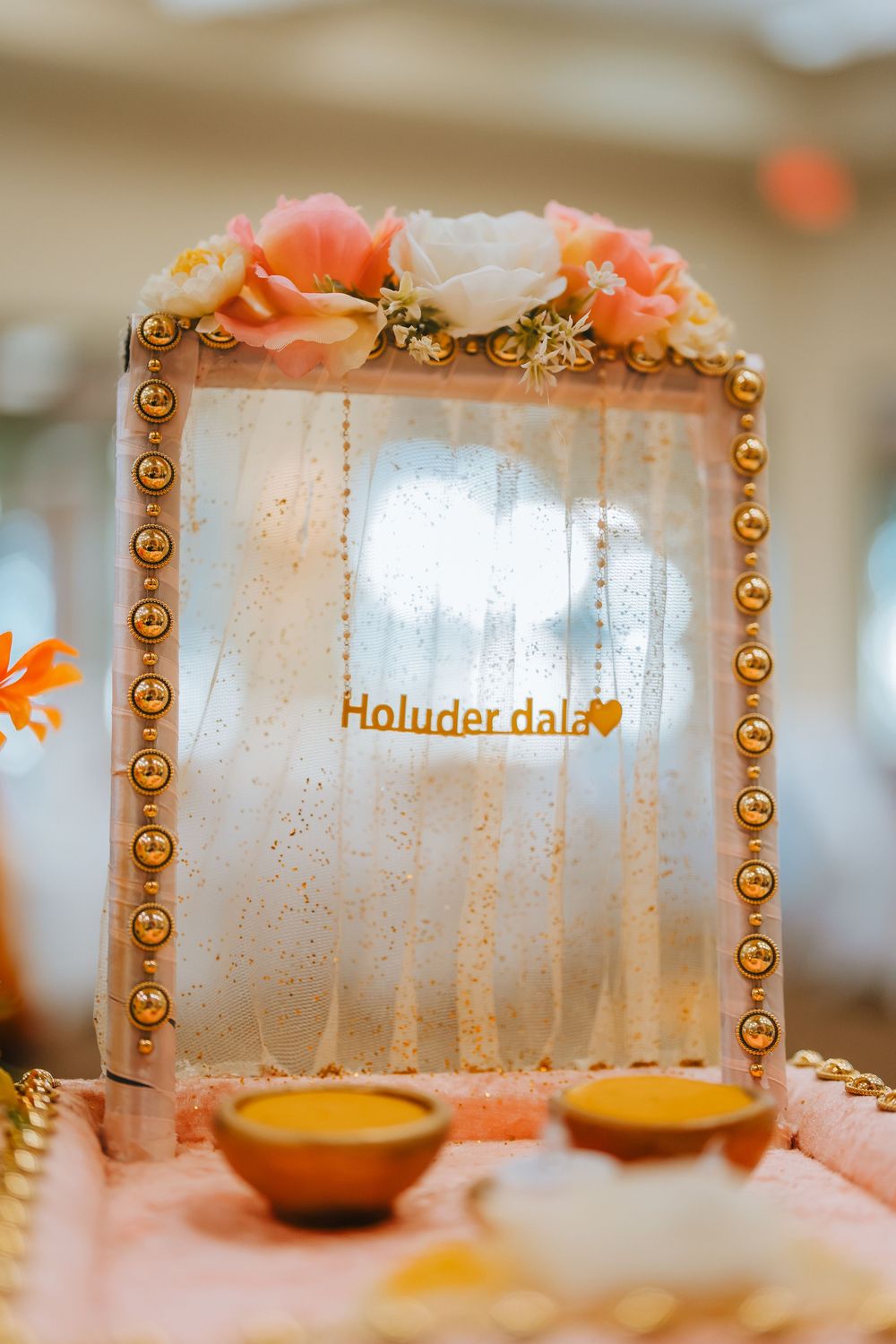 Elegant glass table decor with gold beaded accents and warm lighting creates a romantic wedding reception atmosphere.