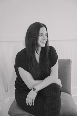 A woman in a black top and plaid pants sits casually on a couch in a series of candid poses.