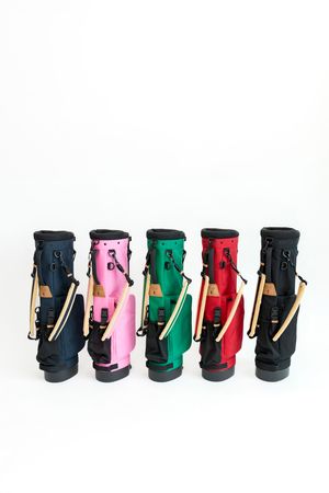 Five colorful golf bags lined up showing navy, pink, green, red and black options for website listing