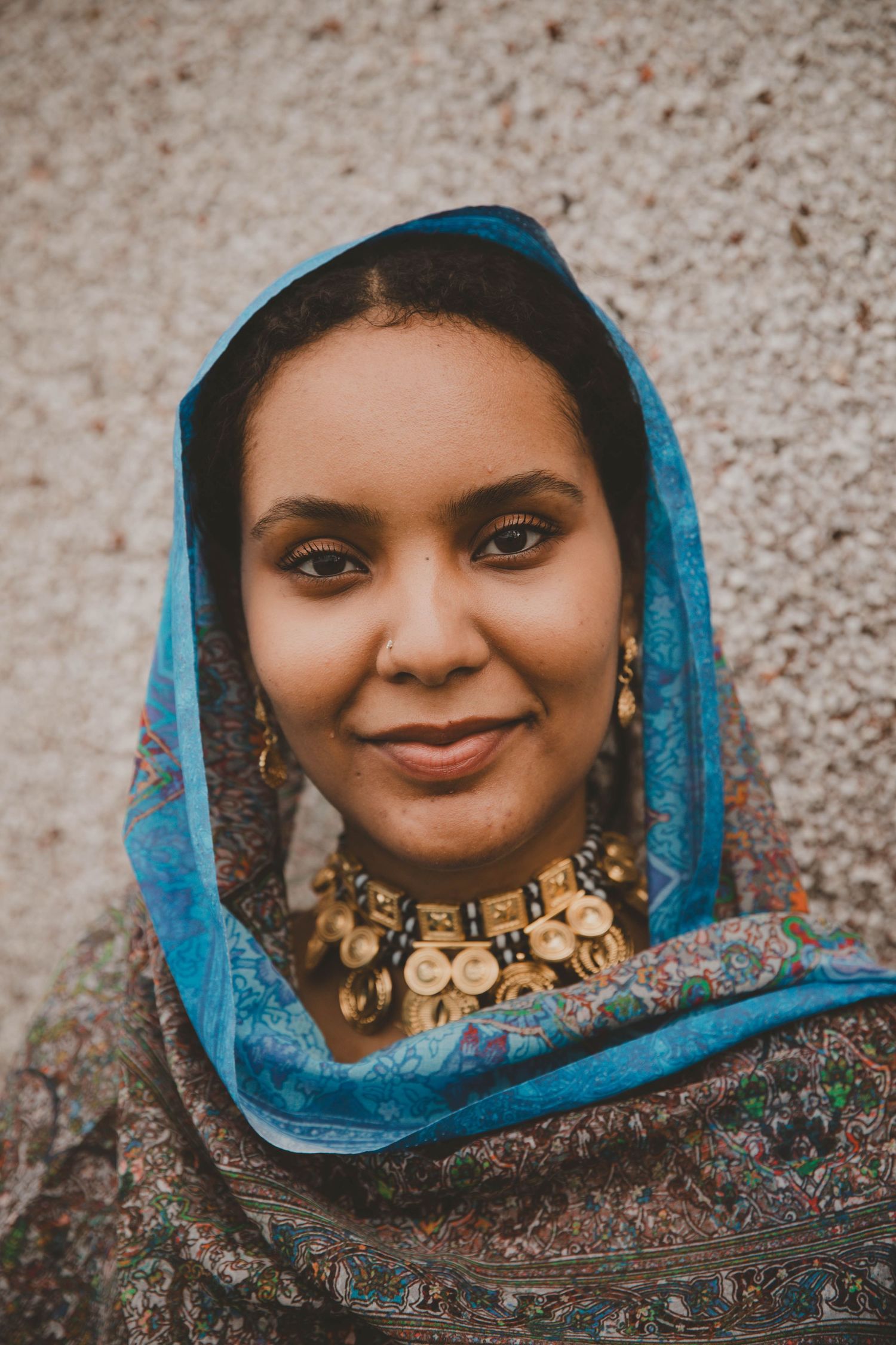 Portrait of Sudanese/Welsh Model, wearing silk Toub in  WALES, designed by HIMA RAHAMA. Jewellery by KUKU Jewellery