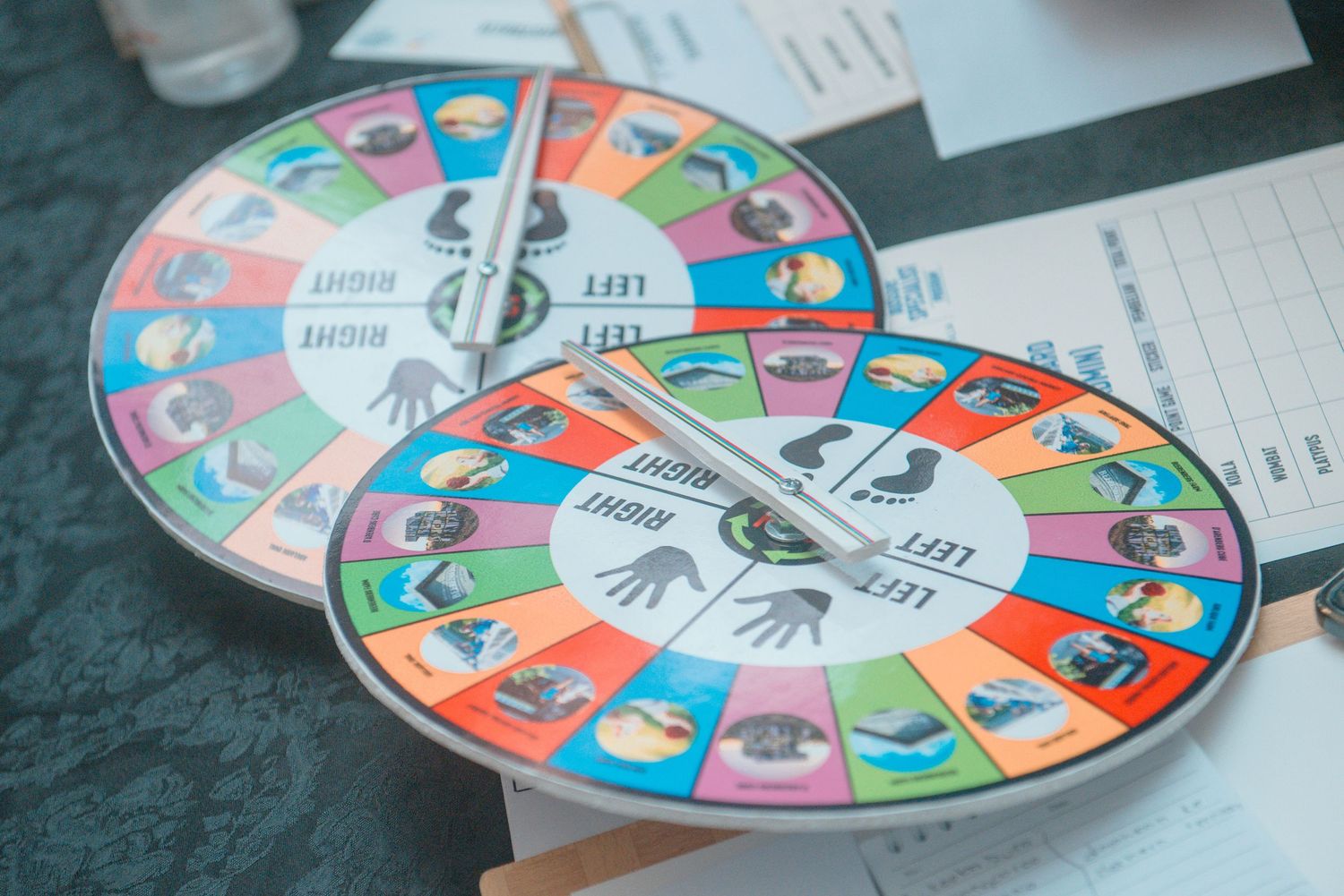 Colorful circular game board with spinning arrow divided into segments showing different activities and choices.