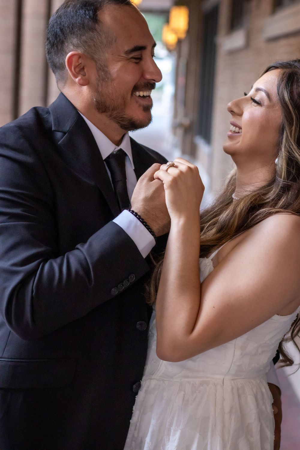A couple in wedding attire share intimate laughing moments in a series of romantic photos.