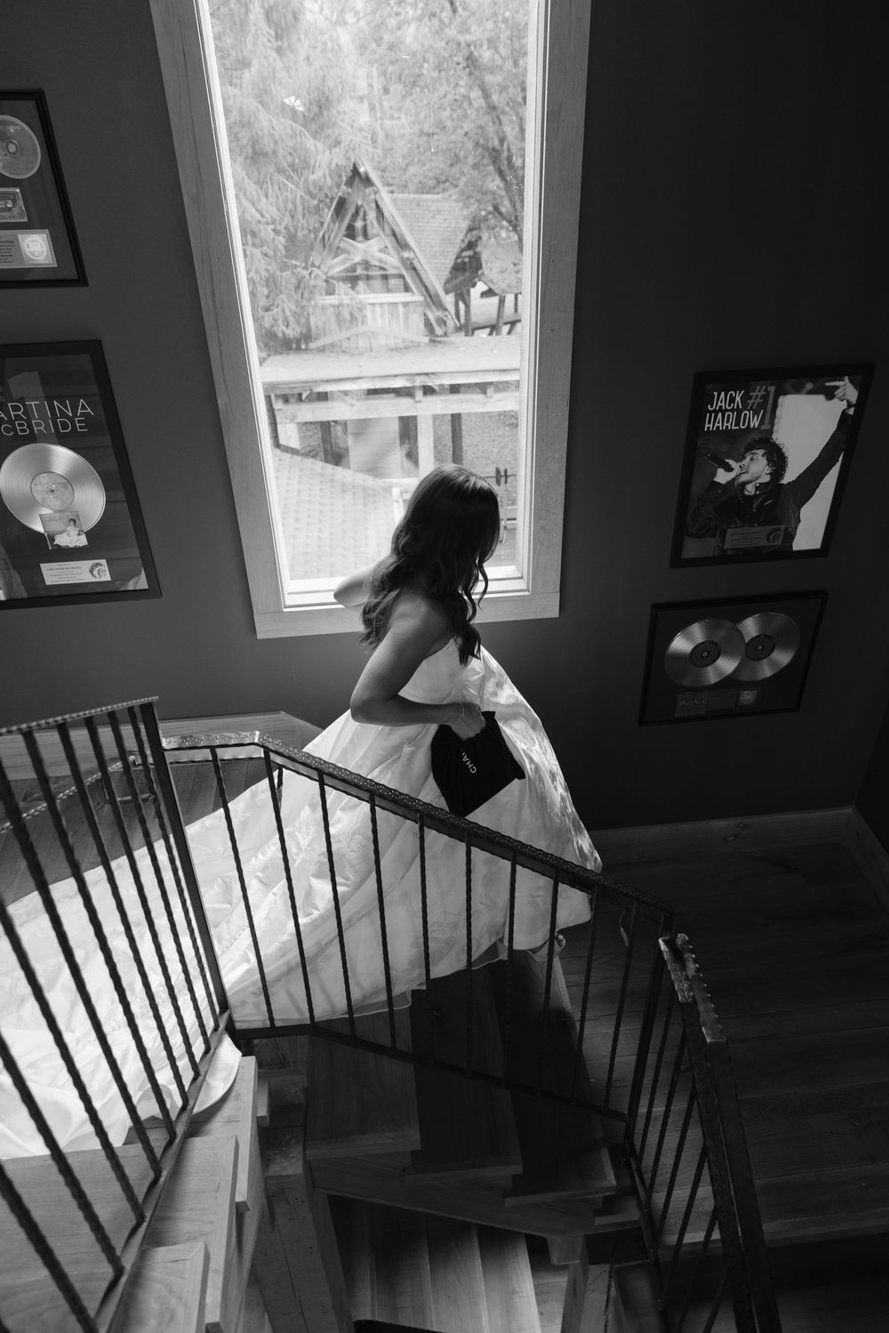 A sequence of artistic black and white photos showing movement and dance poses on a staircase.