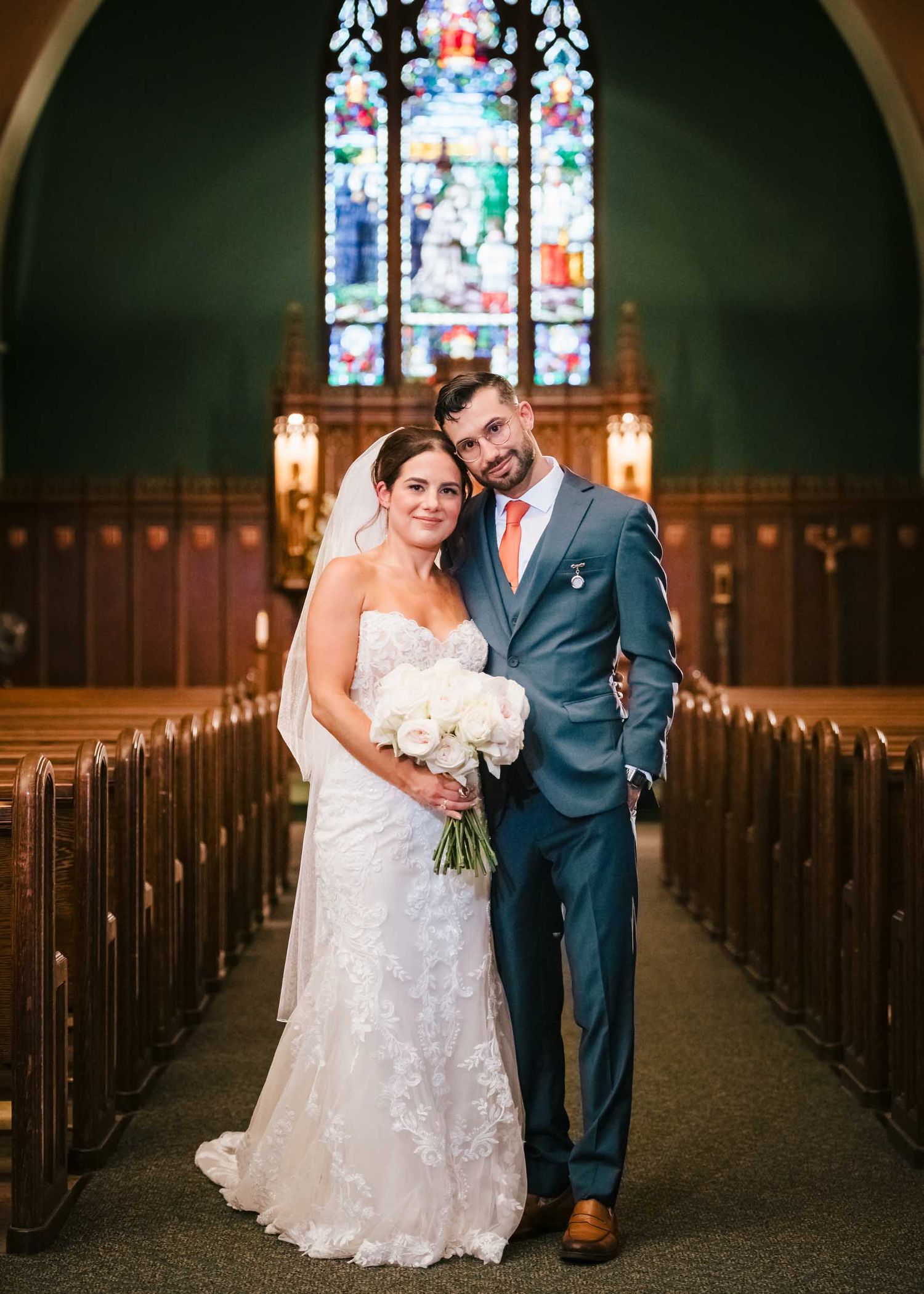 Bride and groom posing for a wedding portrait inside Saint Brigid Church in South Boston after their ceremony