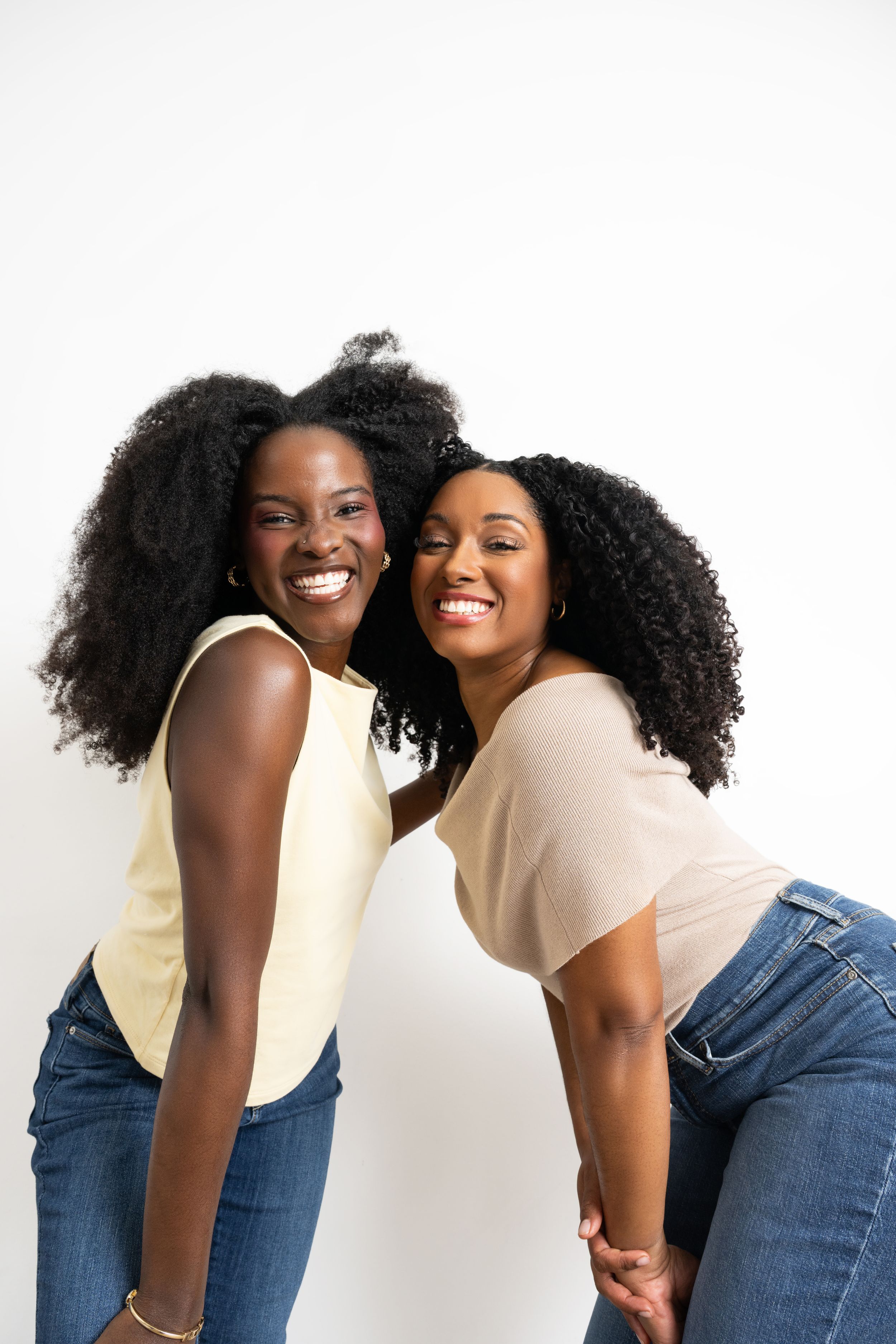 Four candid photos show joyful friends in casual denim and cream outfits laughing together against a white background.