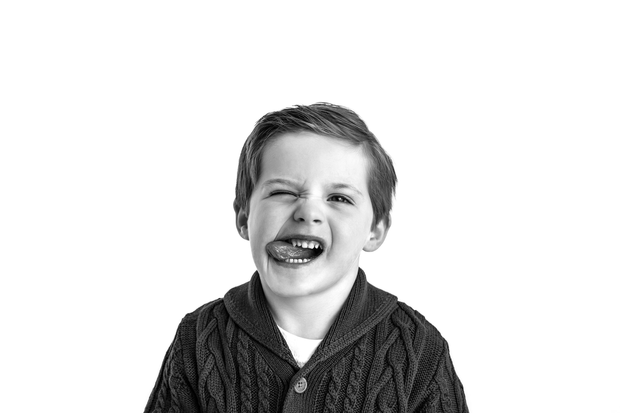 A black and white portrait series showing expressive emotions and genuine laughter of children.