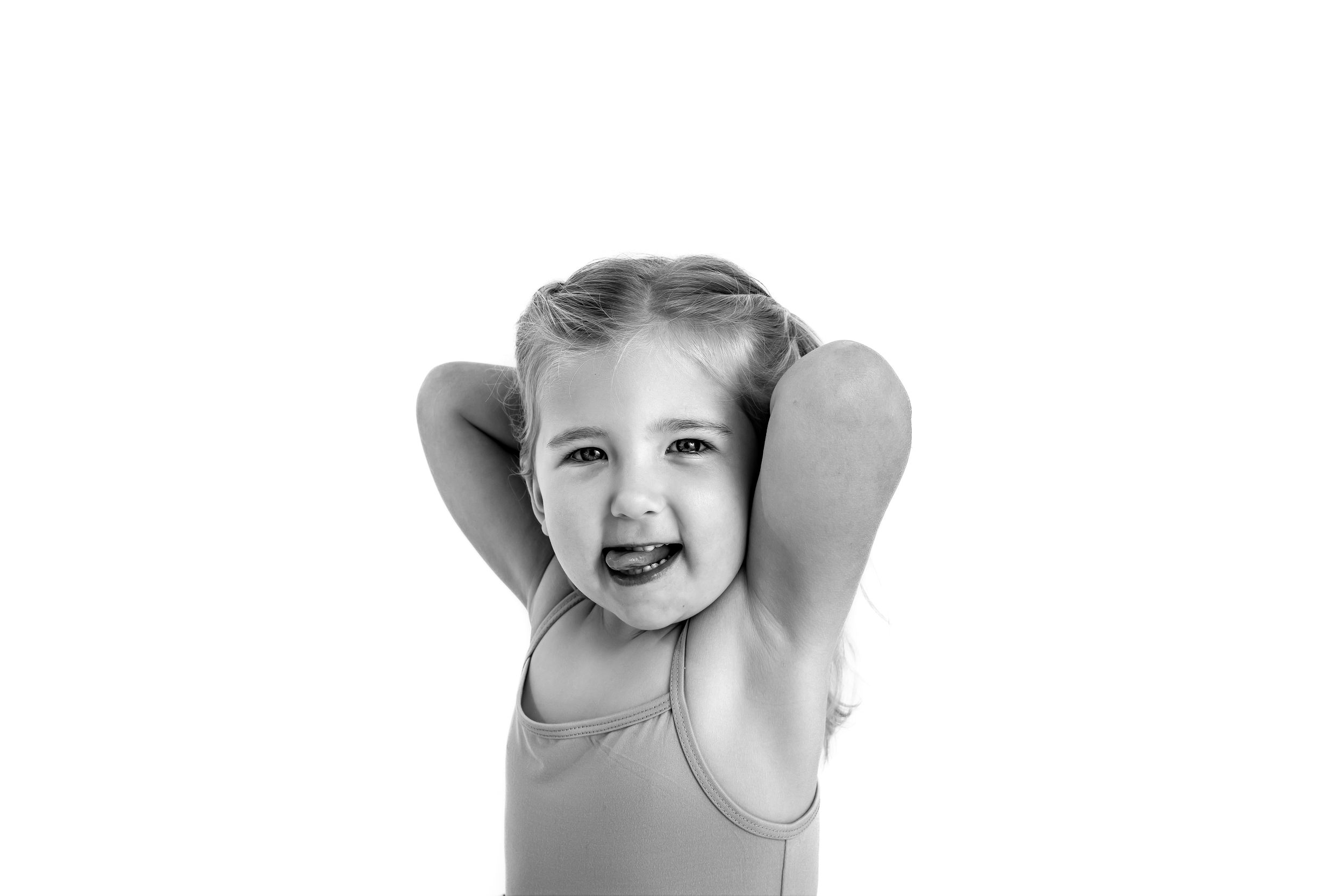 Black and white portrait of a girl making silly faces for personality mini session.