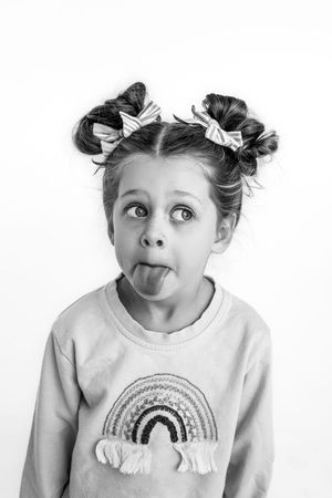 Black and white portrait series showing playful expressions of young children for personailty mini sessions.