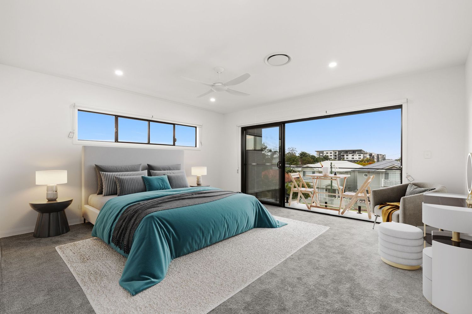 Contemporary master bedroom with teal bedding, ceiling fan, floor-to-ceiling windows, and balcony with suburban views.