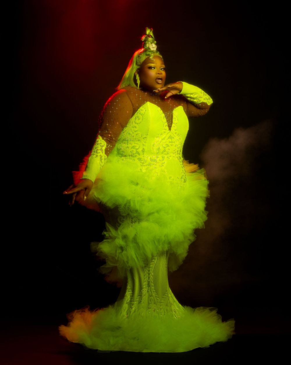 A performer in a neon yellow tulle dress dances expressively against a dark background in a series of dynamic poses.