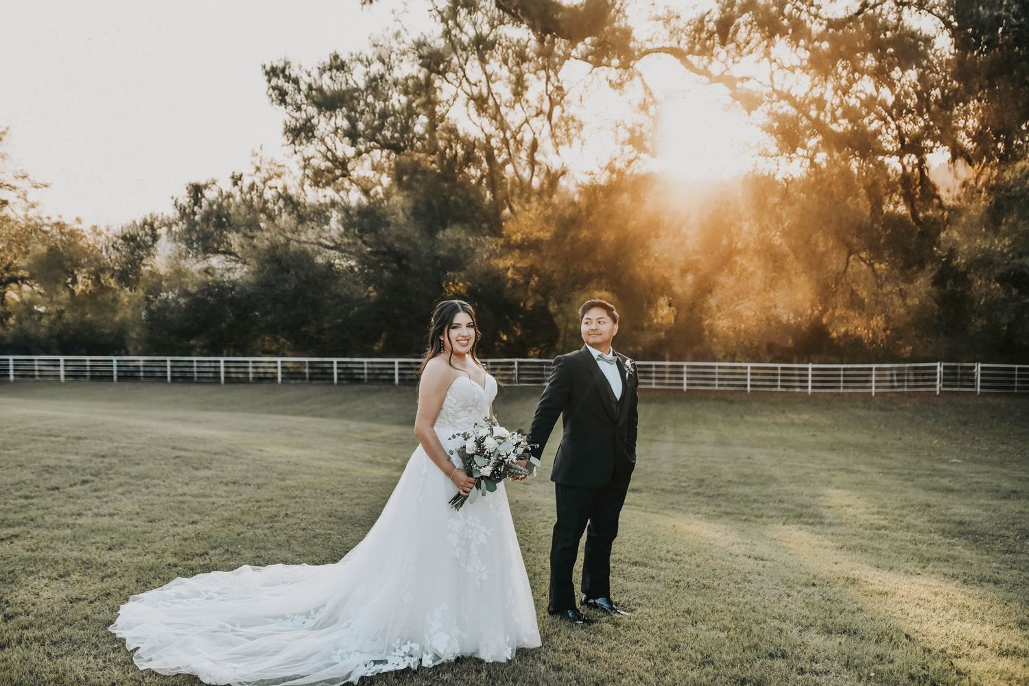 Bride and groom waling hand in hand during sunset wedding photos