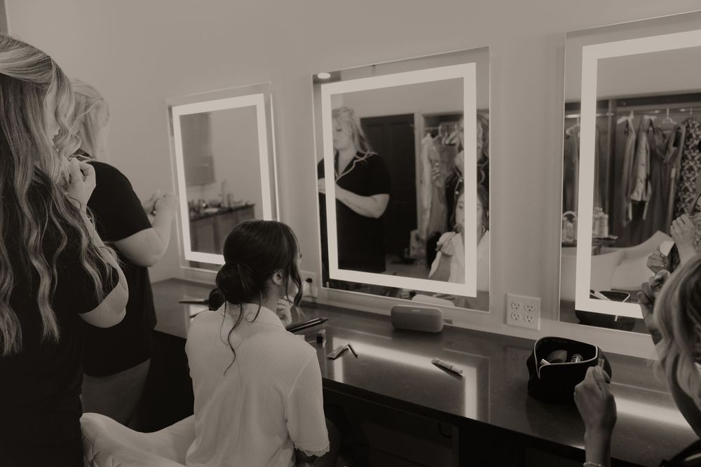 Black and white photos displayed in a gallery setting with framed artwork on white walls.