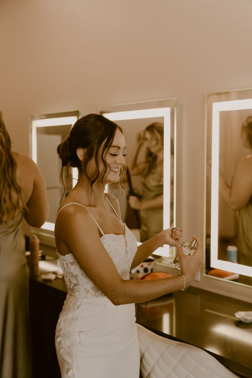 Getting ready scenes in a dressing room with illuminated mirrors and formal attire.
