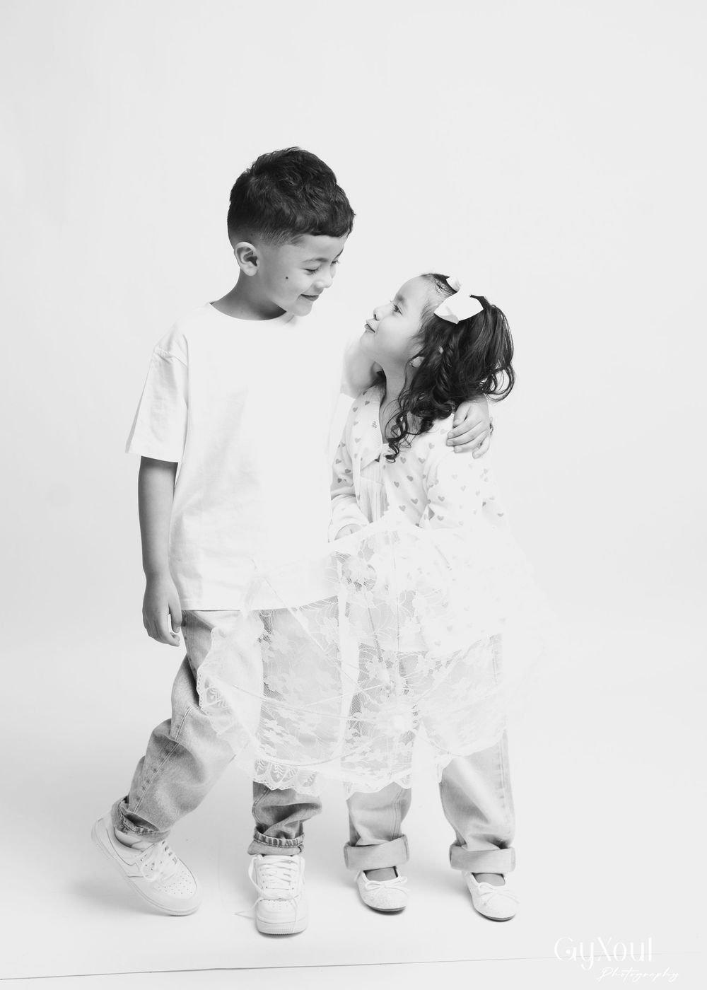 A series of black and white photos showing someone wearing white clothing against a light background.