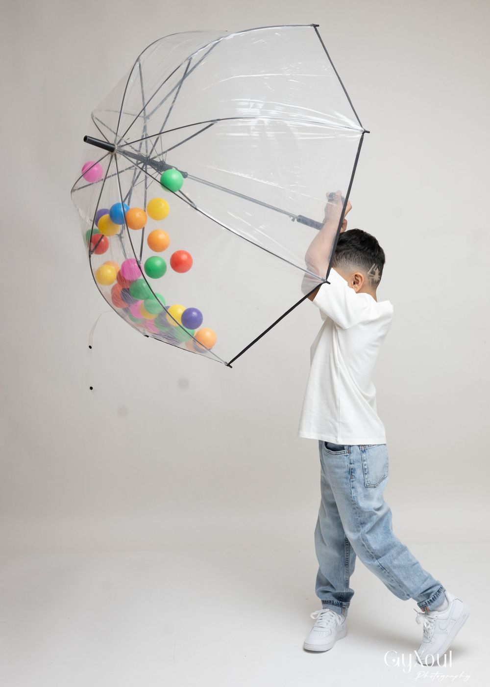 A series of photos showing a clear umbrella filled with colorful balloons against a white background.