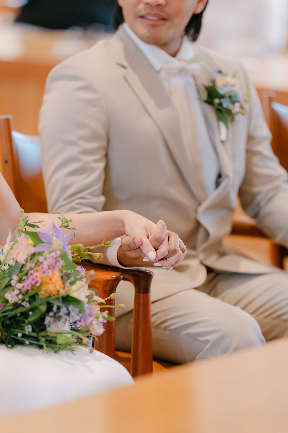 Four cropped photos showing people in beige suits sitting in wooden chairs with floral bouquets at a formal event.