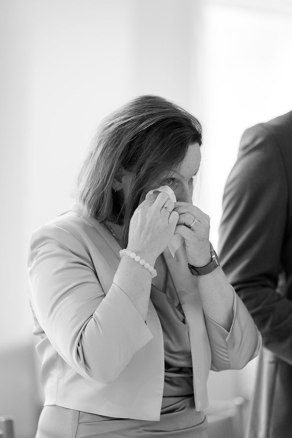 Series of emotional black and white photographs showing someone in distress with hands covering face.