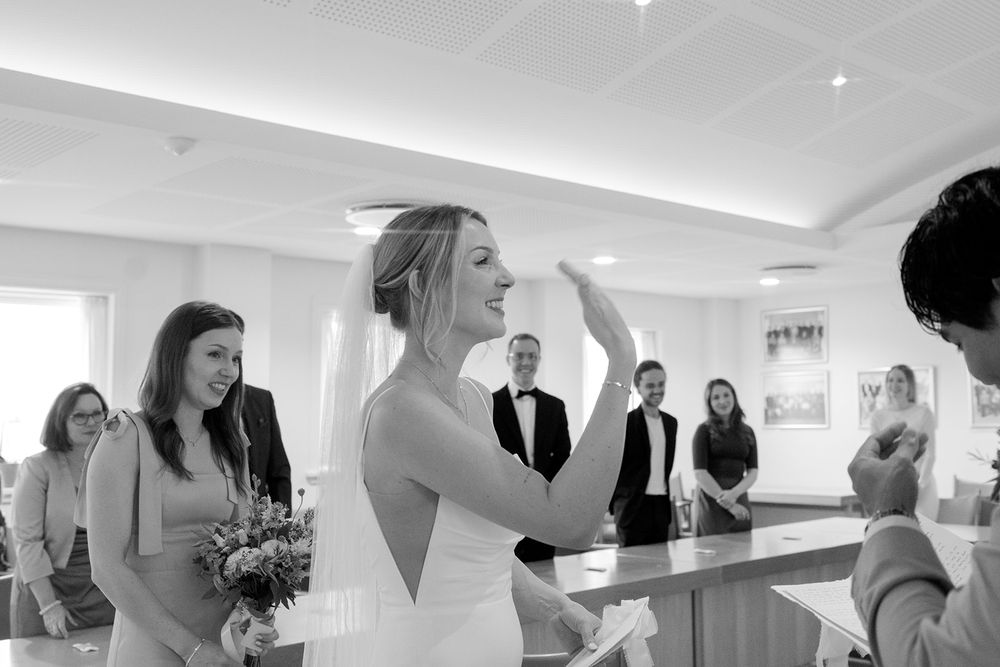 A sequence of black and white wedding preparation photos showing bridal party getting ready in a bright room.