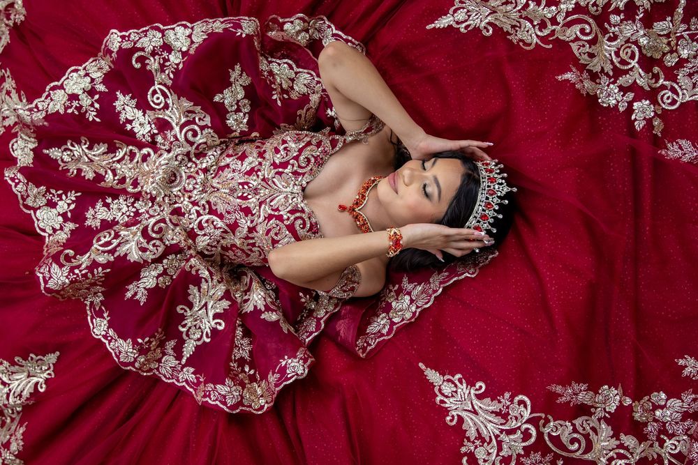 Deep red quinceañera gown with elaborate silver embellishments captured in artistic detail shots.