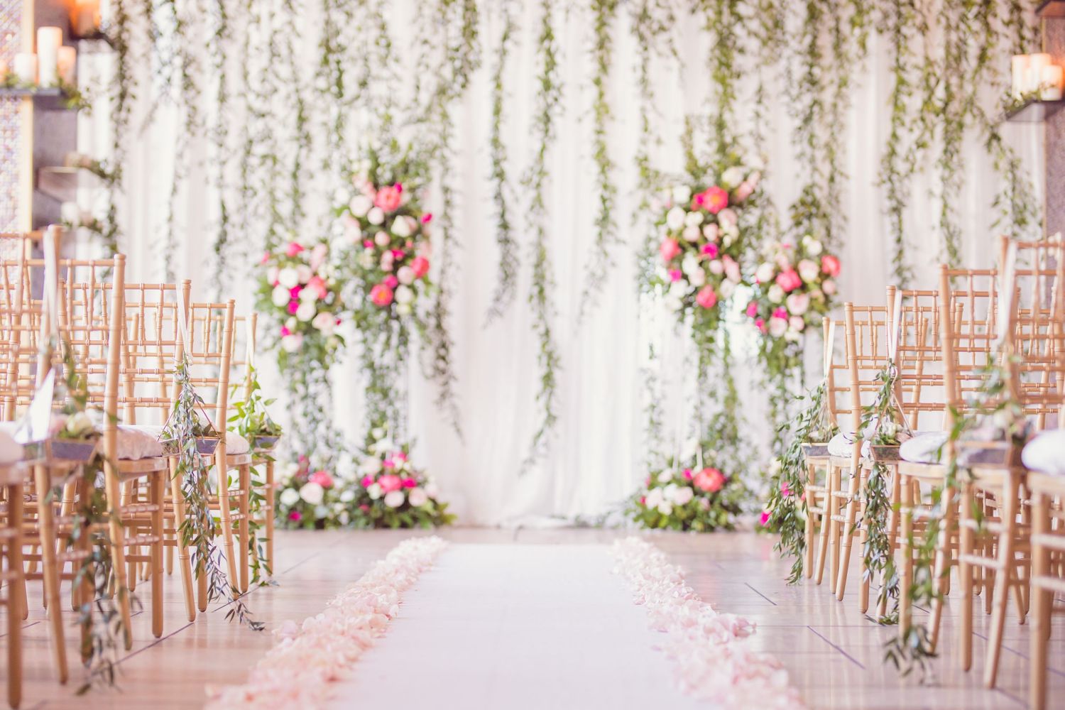 Black and white wedding photos showing a bride in a flowing white dress with a long veil in an elegant hallway setting.