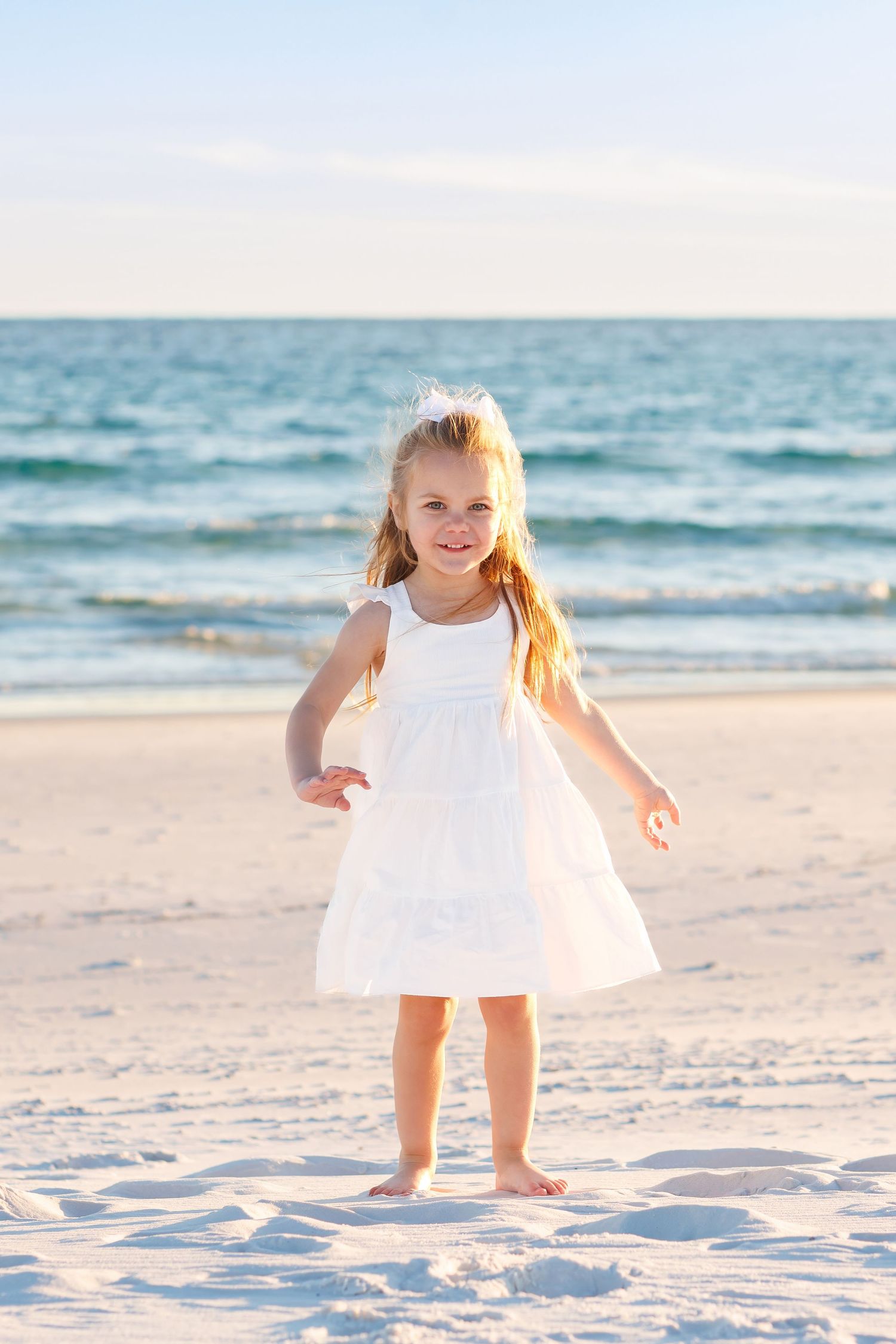 Child playing on the beach at sunset