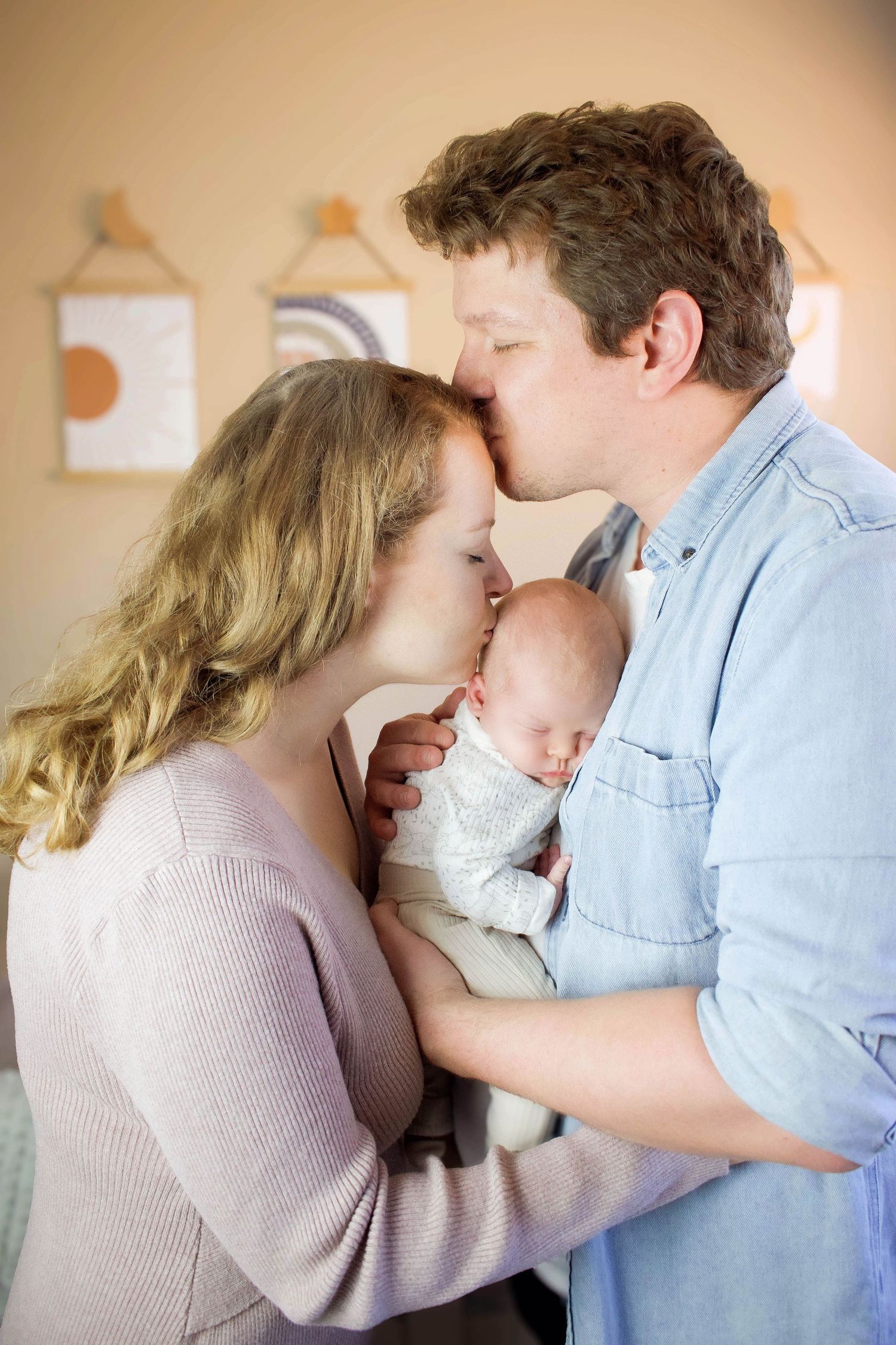 Intimate family moment captured in soft muted tones and natural poses.
