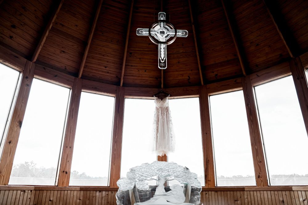 Wooden chapel interior with cross and windows creating a sacred wedding ceremony space.