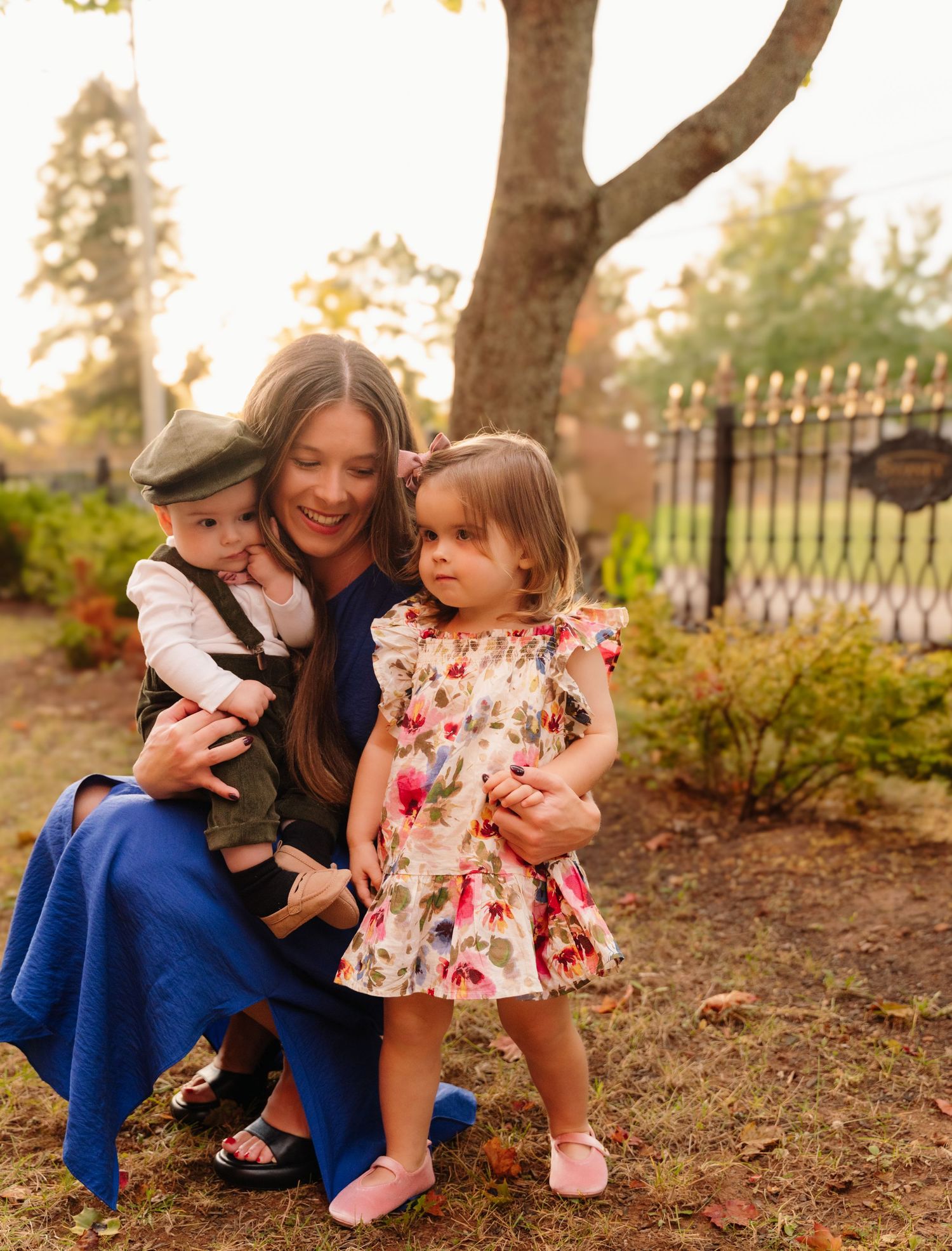 Family moment outdoors with children in casual attire during autumn.