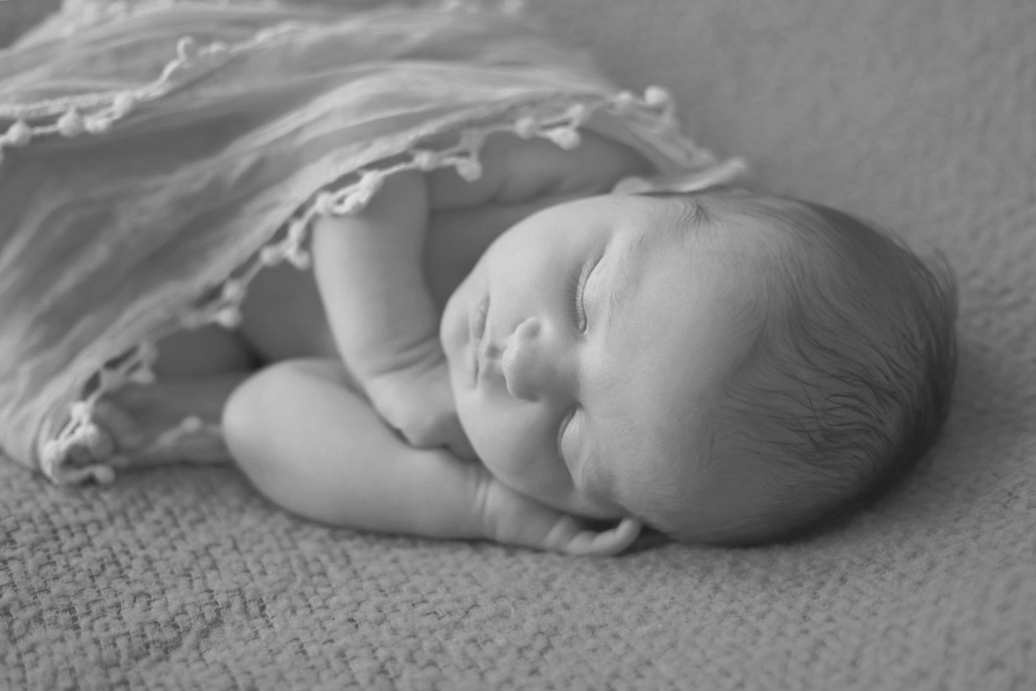 baby sleeping on blanket