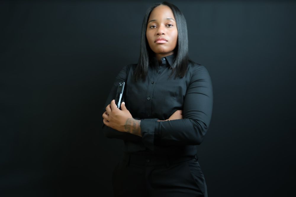 Dramatic portrait of someone in black clothing against dark background.