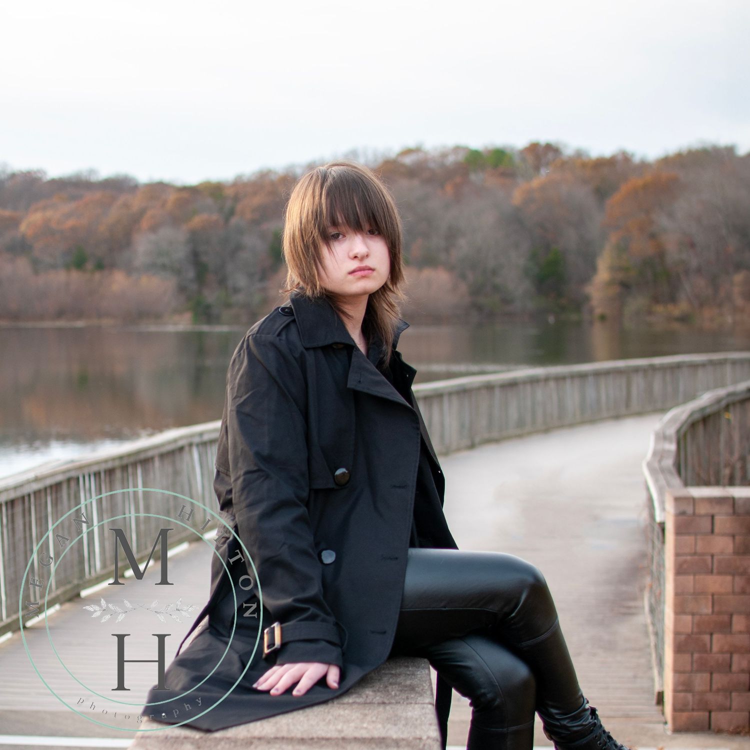 senior sitting on top of brick wall at Lake Fairfax Park photo