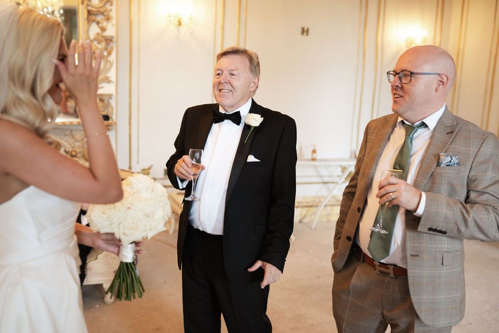 A series of wedding photos showing candid moments between guests and the couple during a formal reception.