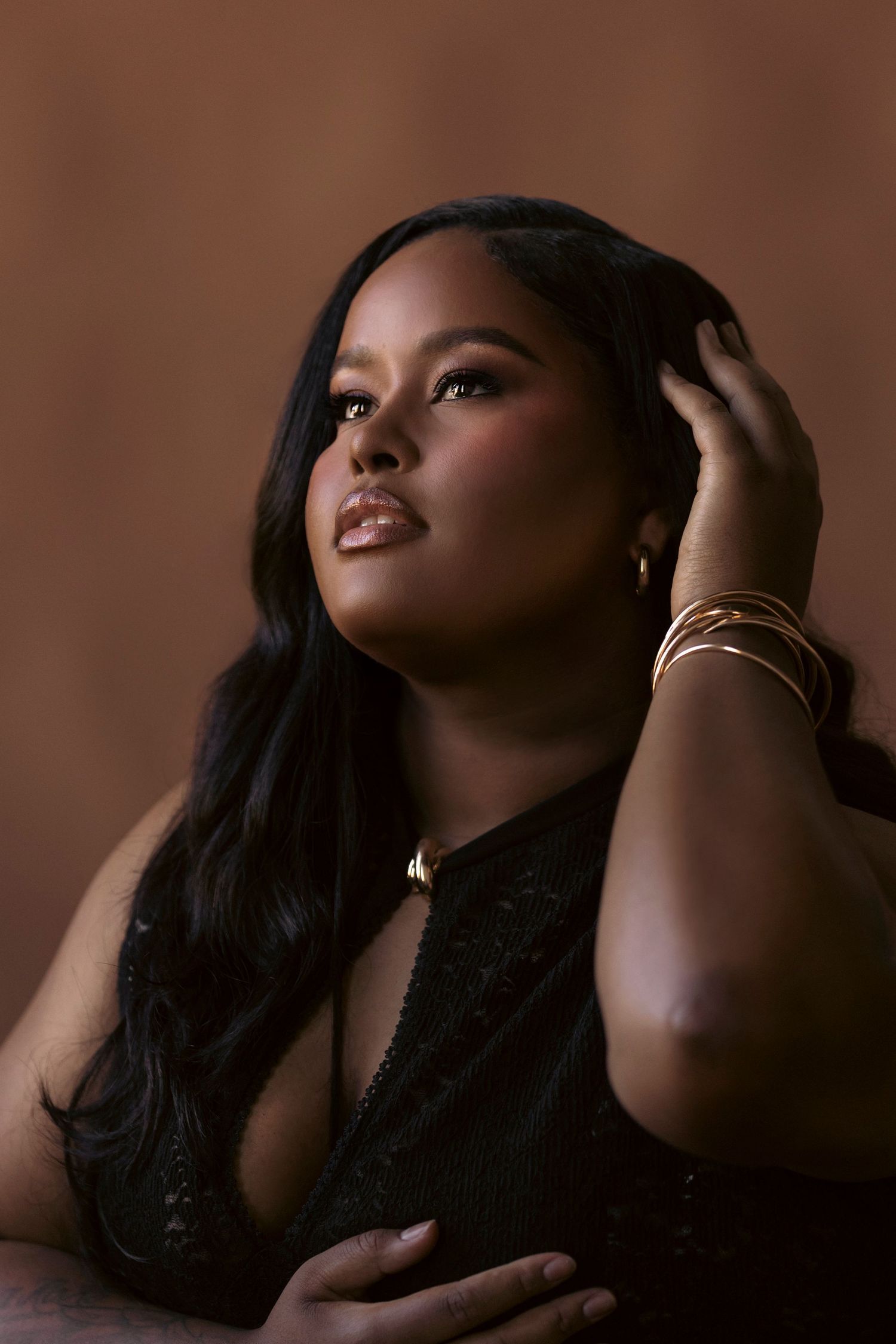 A series of artistic boudoir portraits showing dramatic poses against a dark brown backdrop.