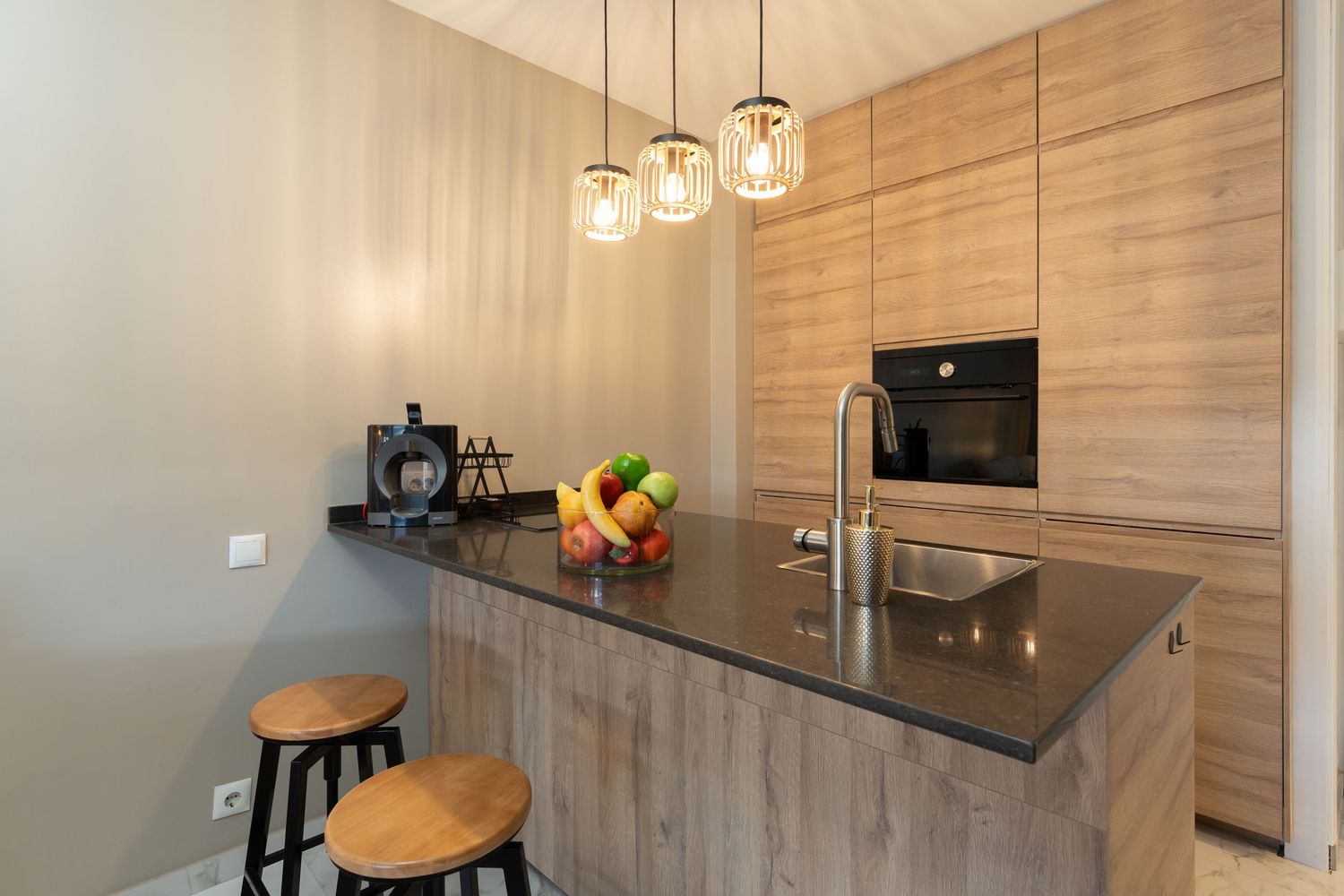 Modern minimalist apartment interior with white walls, grey furniture, and natural light flowing through large windows.